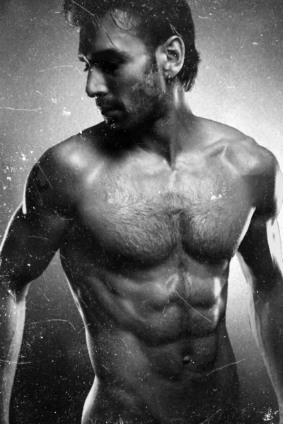 Sexy fine art portrait of a very muscular shirtless male model looking