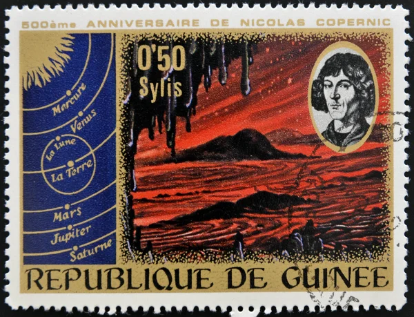 GUINEA CIRCA 1973: stamp printed by Guinea, dedicated to the anniversary of Nicolas Copernicus shows Primeval Landscape, circa 1973