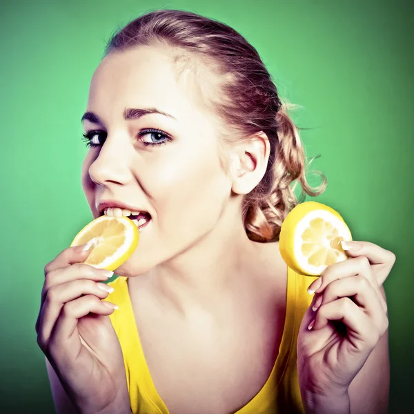 Portrait of beautiful woman, she eating fresh lemon