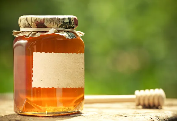 Flowery honey in glass jar