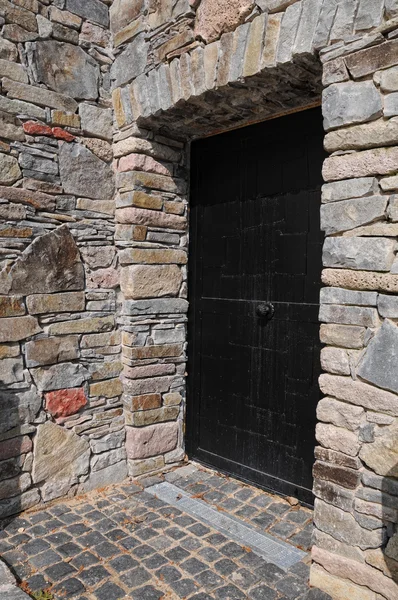 Metal door in a stone wall