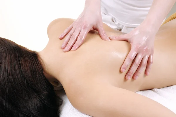 Woman receiving back oil massage