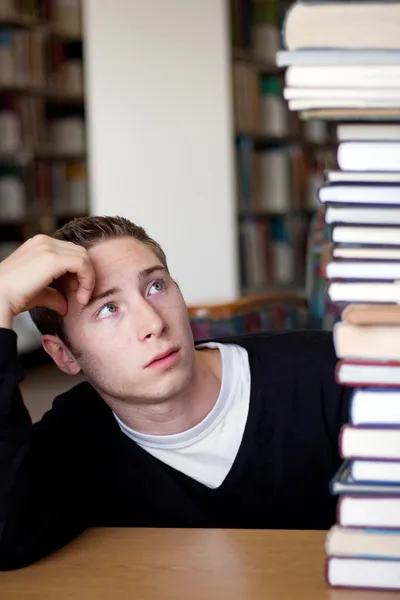 Stressed Student Looks At Book Pile