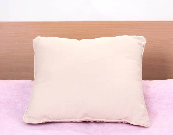 Pillow on bed on white background