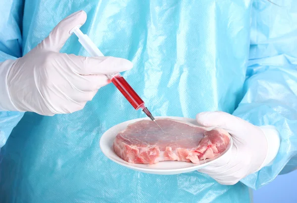 A scientist holds a genetically modified meat