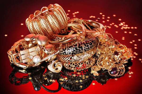 Beautiful golden jewelry on red background
