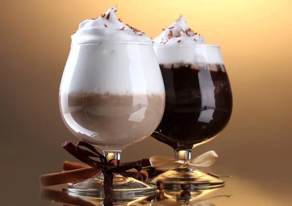 Glasses of coffee cocktail on brown background