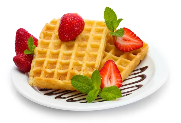 Belgium waffles with strawberries and mint on plate isolated on white