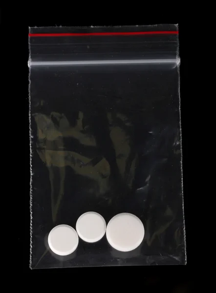 Drugs in package on black background