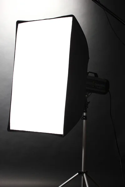 Studio flash with soft-box on grey background