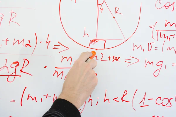 Writing on the whiteboard formulas, closeup