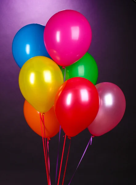 Bright balloons on purole background