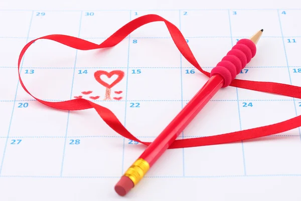 Calendar page with hearts, pencil and ribbon on St.Valentines Day