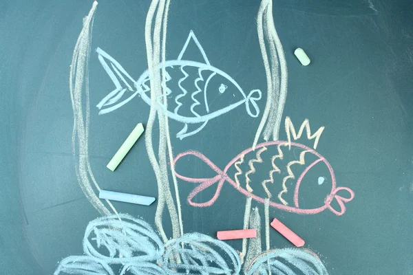 Two fishes, сhild\'s drawing with chalk
