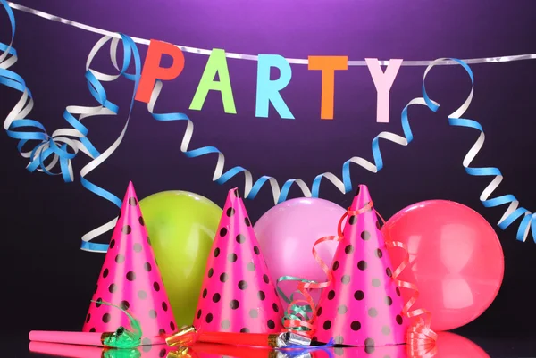 Party items on purple background