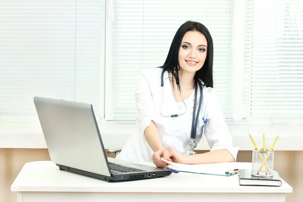 Beautiful girl doctor in the office holding prescription