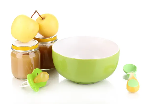 Jars of baby puree with plate, spoon and apples isolated on white