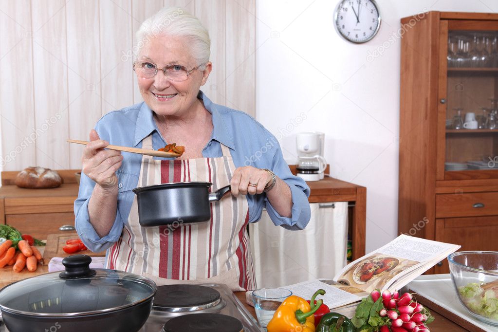 Older woman cooking a meal — Stock Photo © photography33 10120865