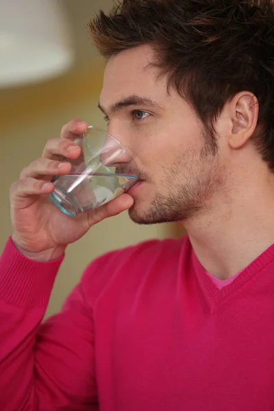 Man drinking glass of water