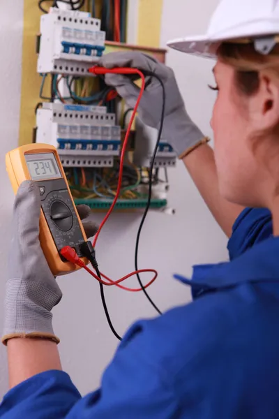 Female electrician with voltmeter