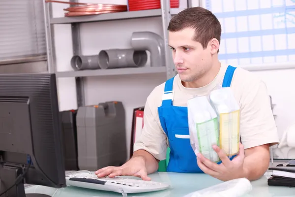 Man checking plumbing products on a computer database