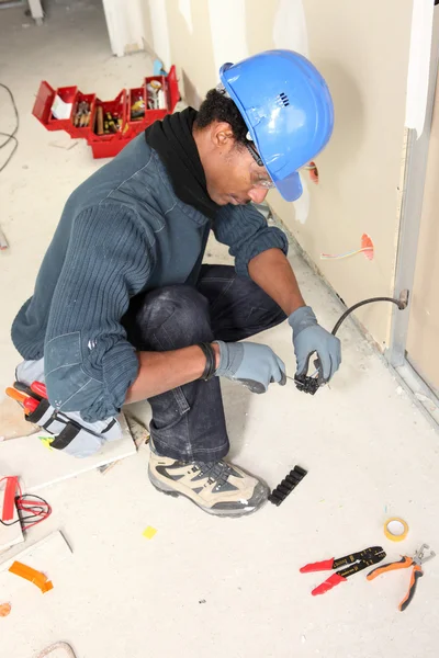 Electrician wiring a building