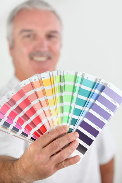 Man holding paint swatch