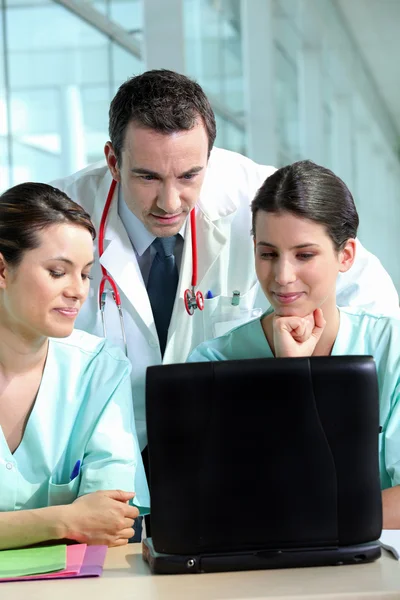 A team of medical professionals consulting patient records