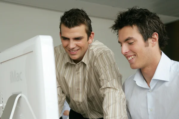 Young men learning computer skills