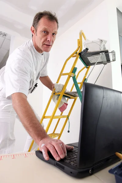 Painter checking instructions on the Internet