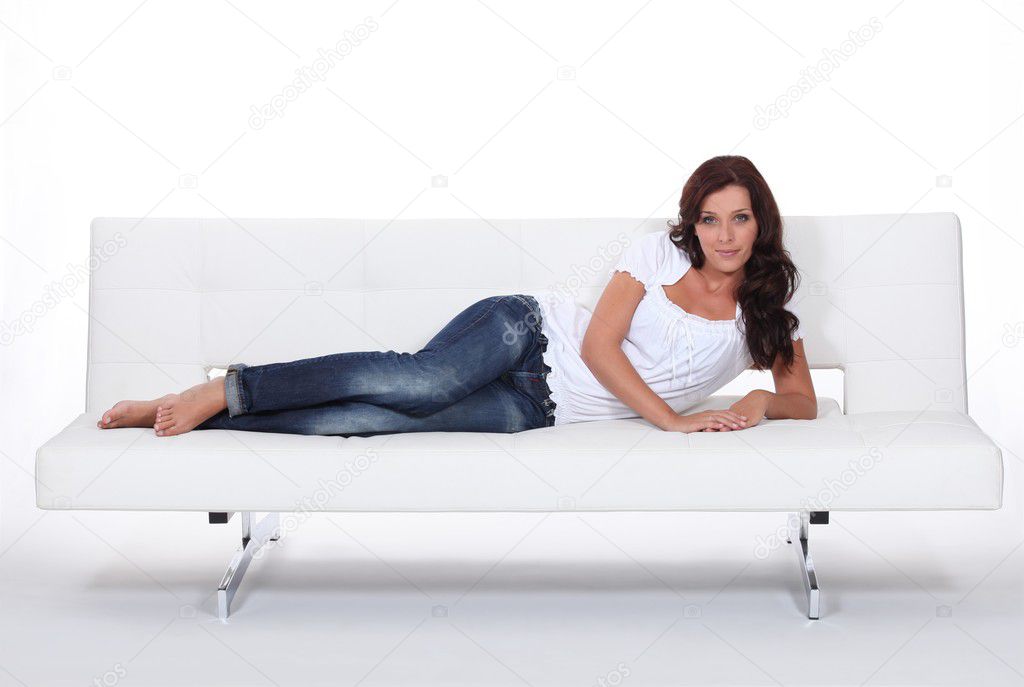 Female model laid on expensive leather sofa | Stock Photo ...