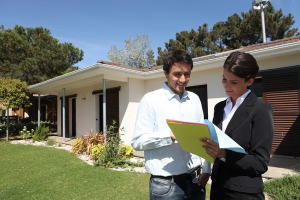 Realtors in front of a house