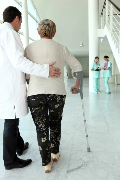 Medical assisting elderly woman in walking