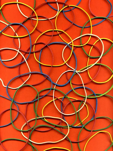 Background from many multi-colored writing elastic bands