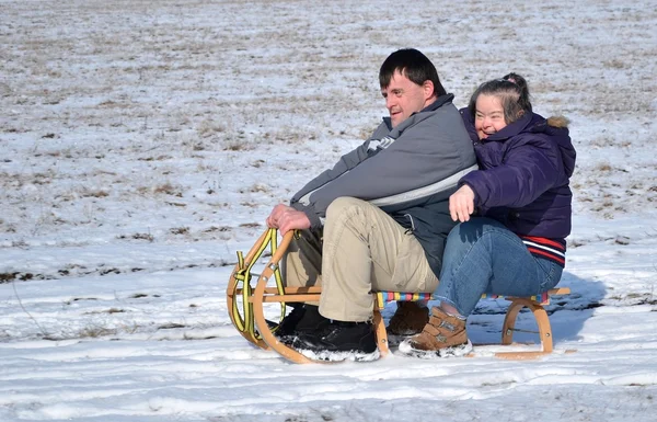 Down syndrome couple sledding