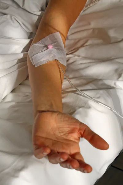 Arm of the patient with a patch for the drip