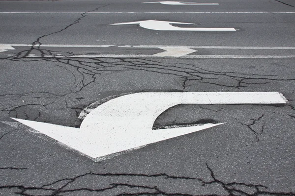 Arrows with cracked asphalt texture