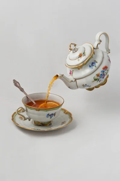 Tea pours into a cup