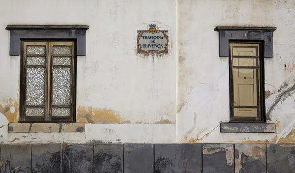 OLD WINDOWS AND STREET SIGN IN PORTUGAL