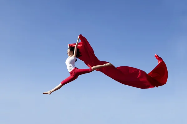 Asian woman jumping expressing freedom