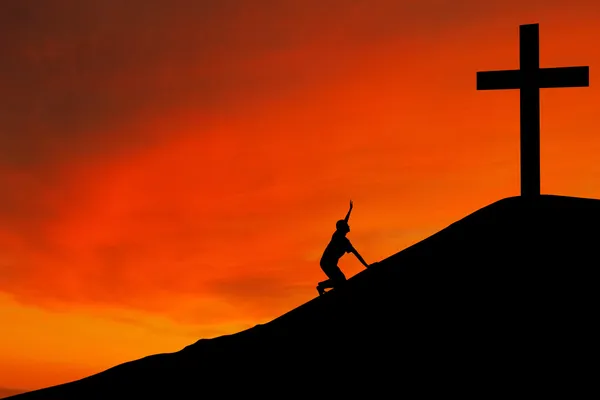 Silhouette of man with the Cross