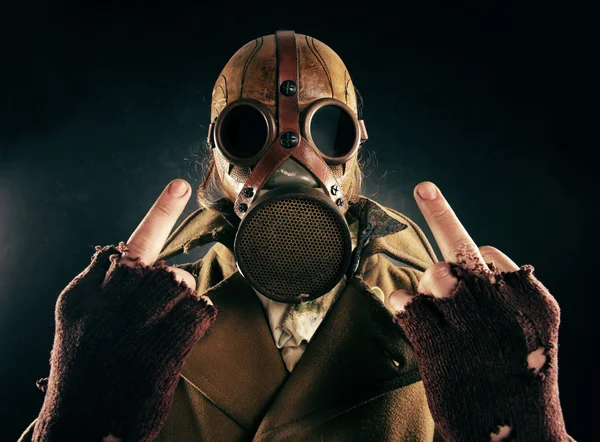 Grunge portrait man in gas mask, fuck sign