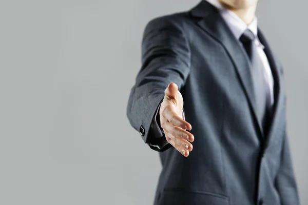 Businessman offering for handshake, close up hand
