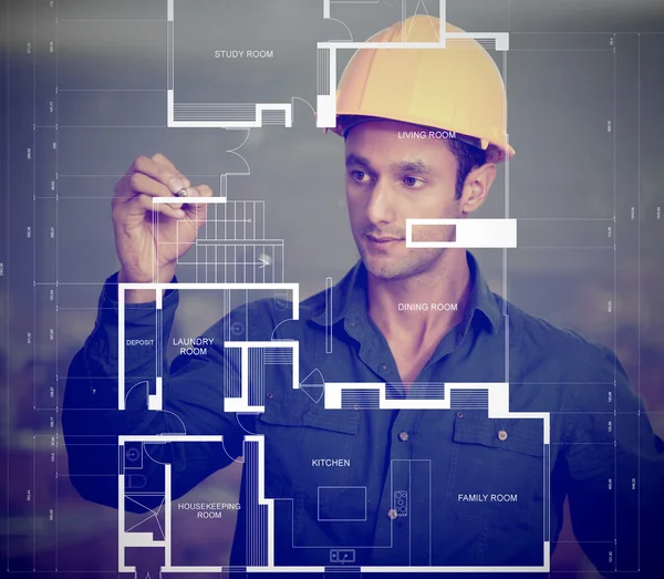 Construction worker sketching blueprints