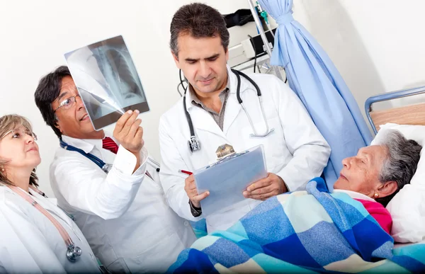 Doctors checking on an elder patient