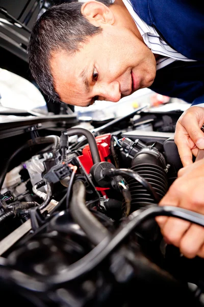 Mechanic fixing car engine