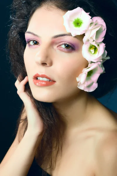 Fashion portrait of female model - beauty girl woman with flowers in her ha