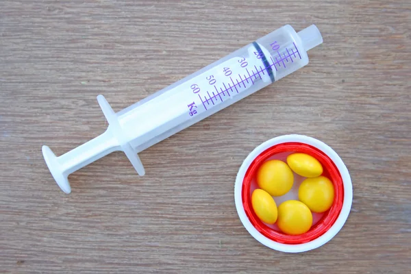 Veterinary syringe and tablets.
