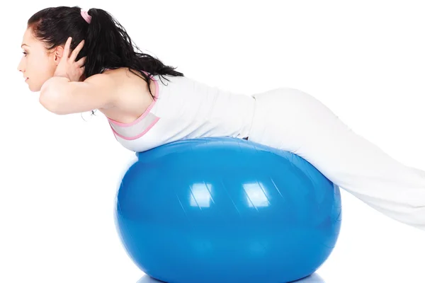 Woman stretching on the blue ball