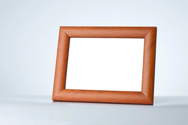 Blank wood picture frame on the table with place for your own text
